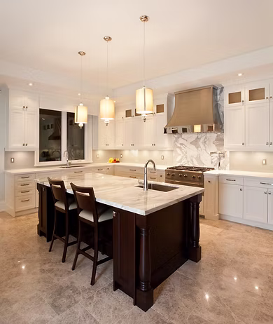 Modern remodeled kitchen with white cabinets and island, a Green Contractors FL renovation project