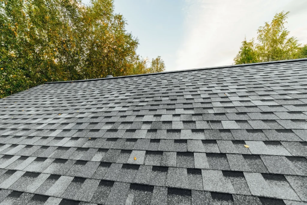 Grey composition shingle roof ridge on a residential home