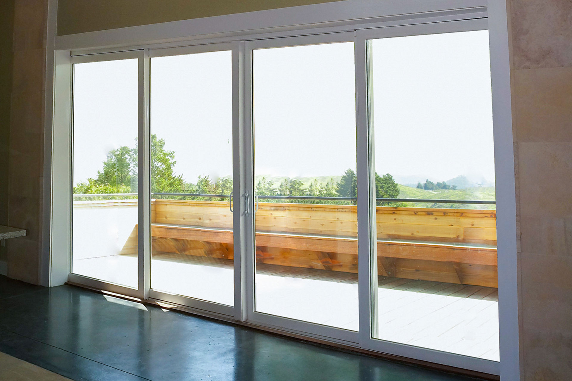 Living area with wide sliding glass doors opening onto a deck
