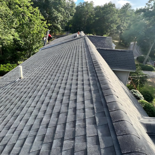 View along the ridge of a grey asphalt shingle roof