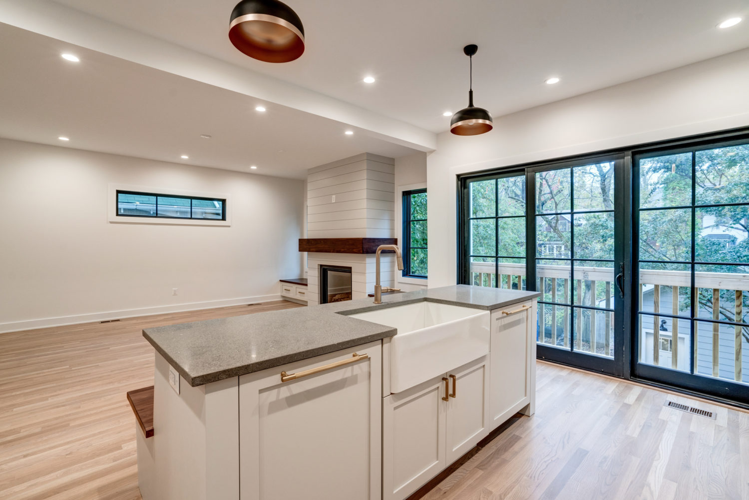 Remodeled open-plan kitchen with an island and sliding glass doors to a balcony