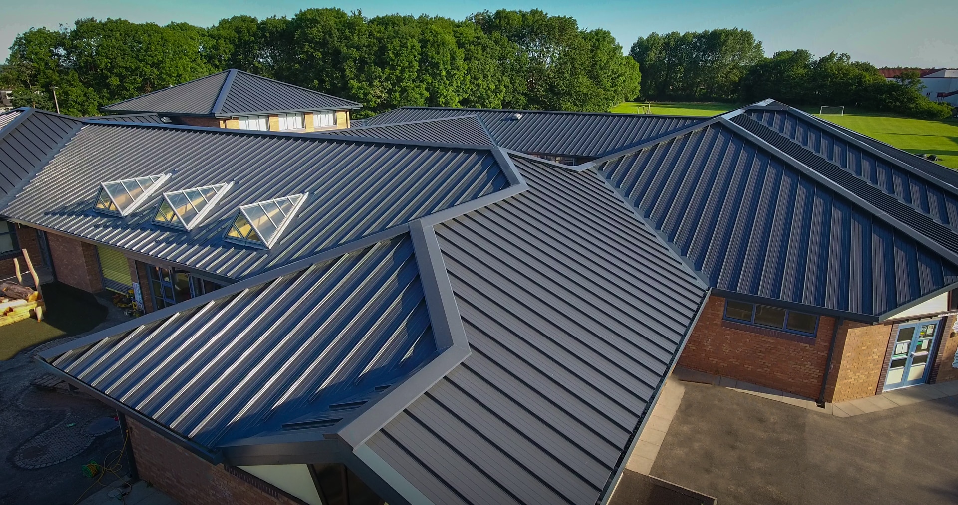 Aerial view of a commercial standing-seam metal roof installation