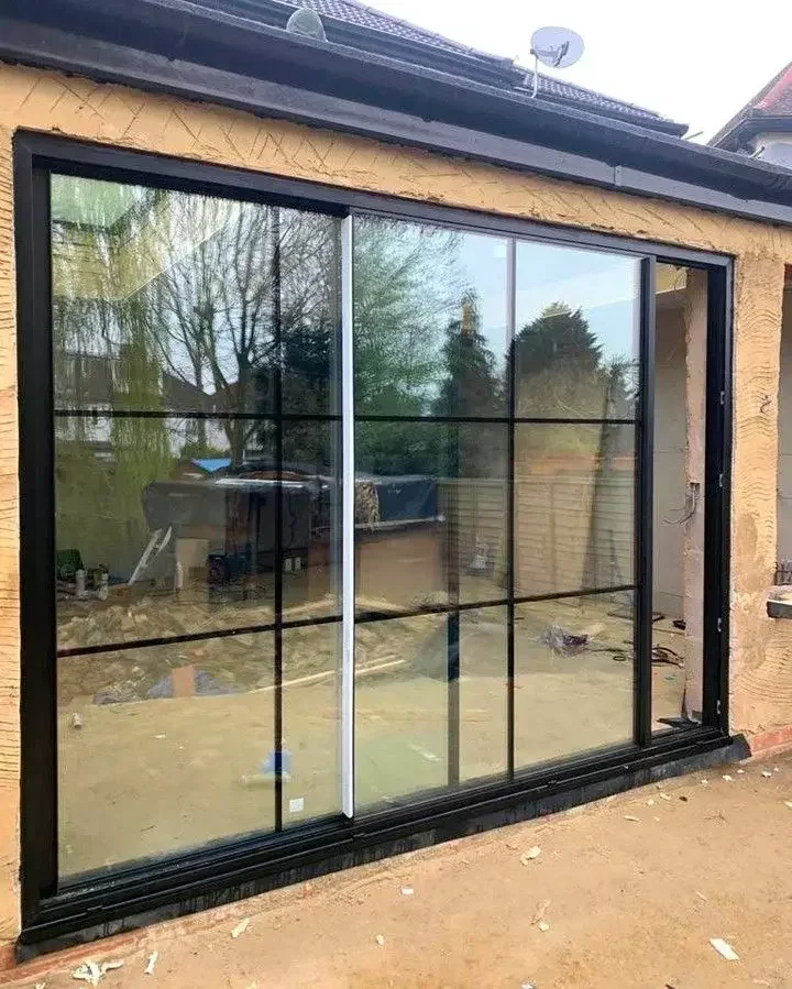 Large black-framed hurricane impact sliding glass door unit installed in an exterior wall