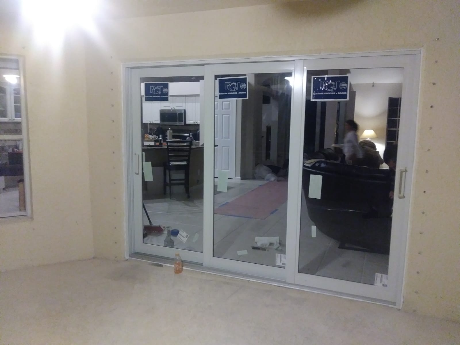 White vinyl sliding glass patio door installed in an empty room