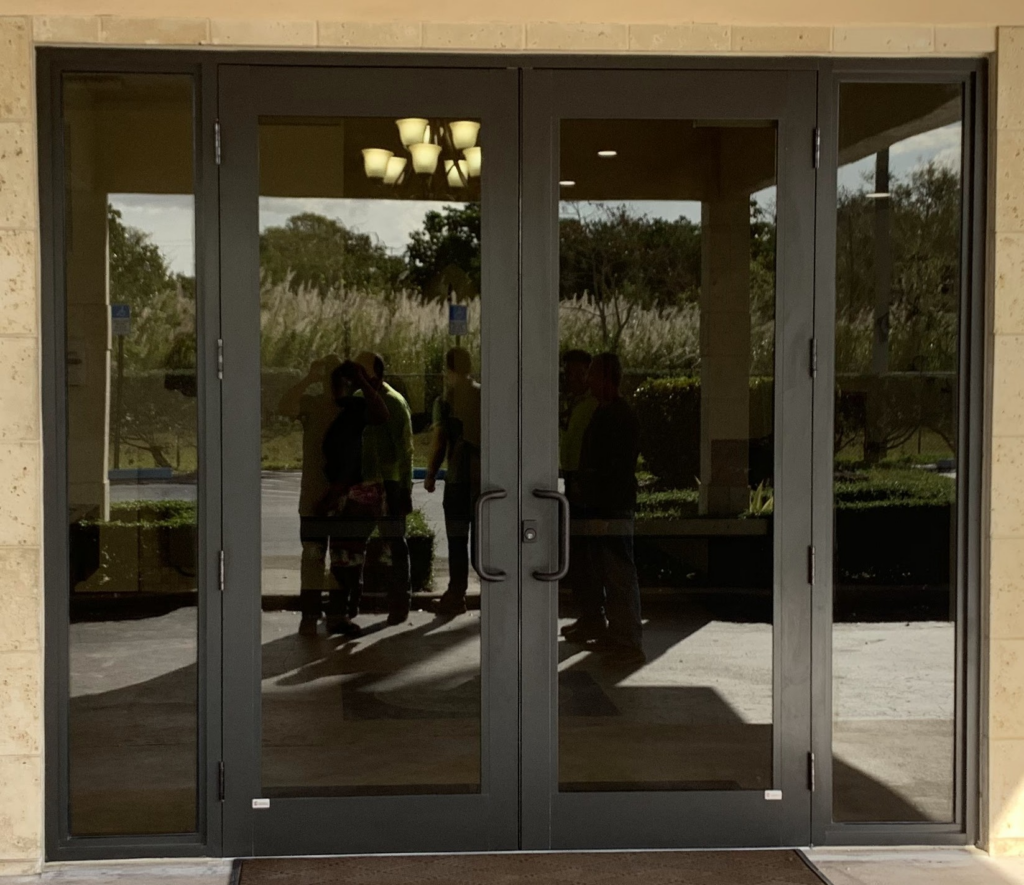 Bronze aluminum double entry doors with impact glass viewed from outside