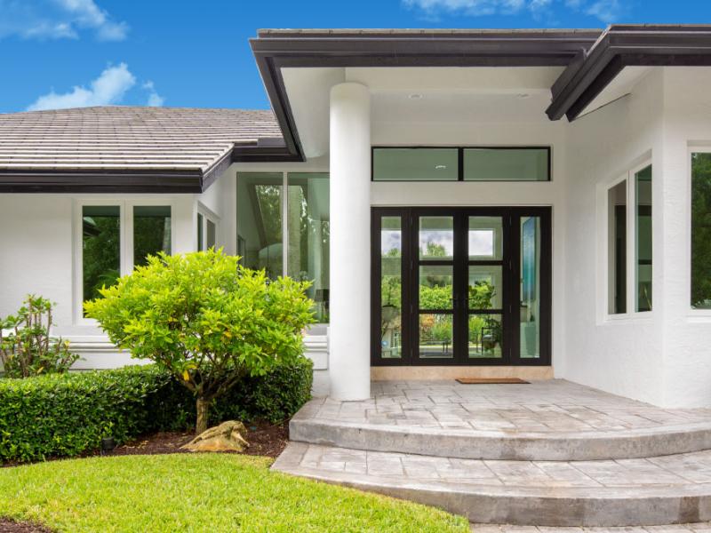 Front entrance of a Florida home with impact entry doors and windows