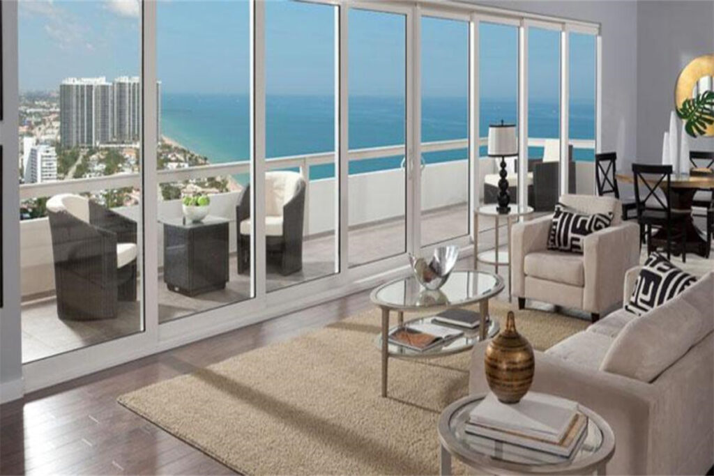 High-rise condo living room with impact laminated glass walls overlooking the ocean