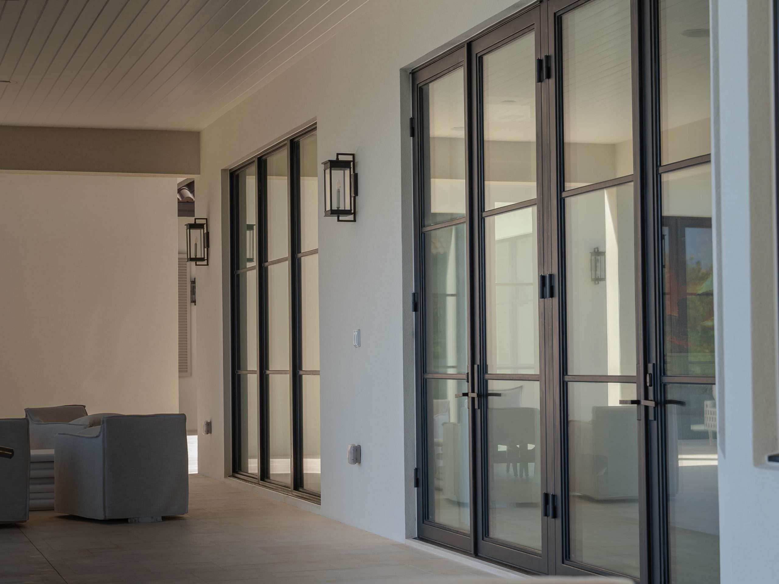 Black-framed impact French doors in a modern home hallway