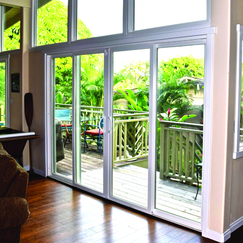 White-framed impact sliding glass doors leading to a wood deck