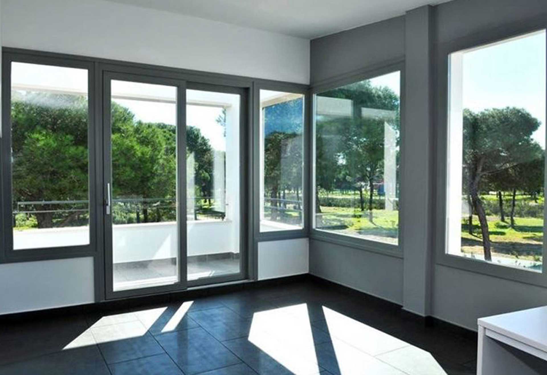 Corner room with floor-to-ceiling impact windows and an impact patio door