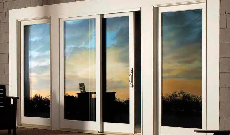 White-framed impact French doors with sidelites at sunset