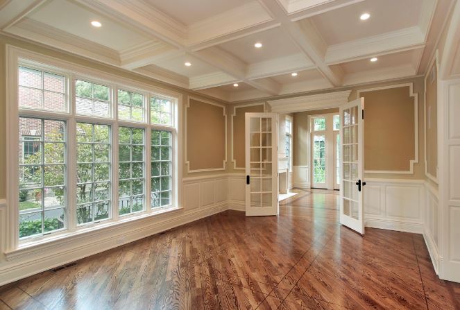Formal room with white grid replacement windows and French doors
