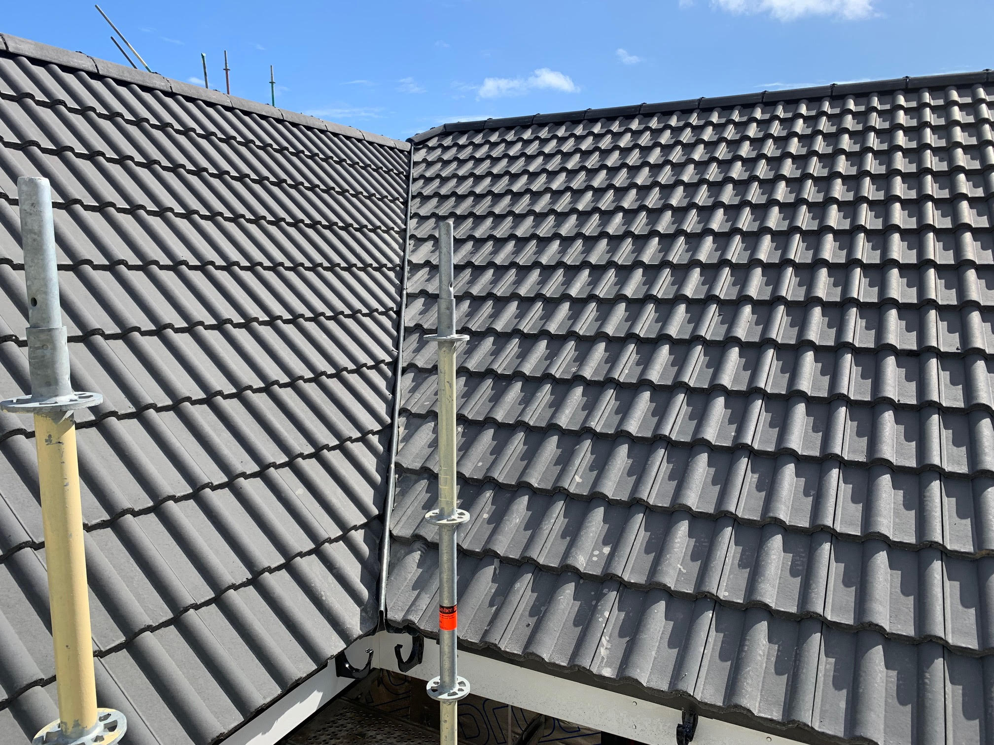 Close-up of a newly installed tile roof with ridge flashing